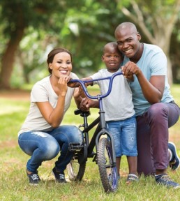 AYFS How Can We Help man and woman with child holding bike
